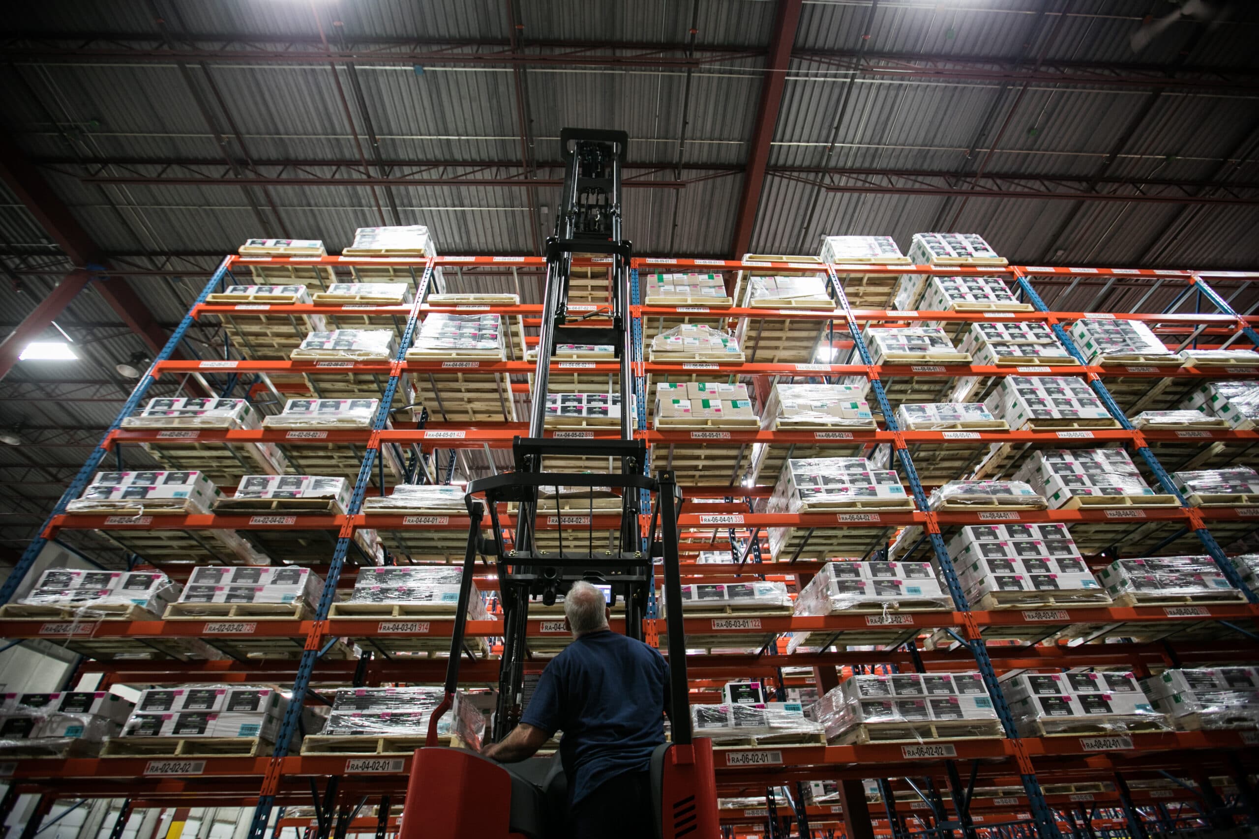 Standing fork lift operating in OCS Distribution Center run by SAP and tested by Merito